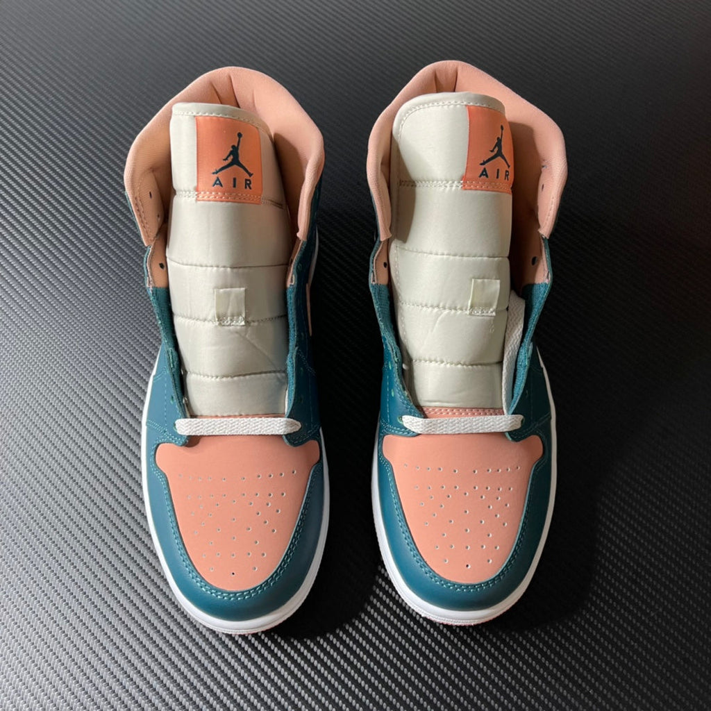Air Jordan 1 Mid pair showing tongue and collar lining, teal blue and peach with lace tops.