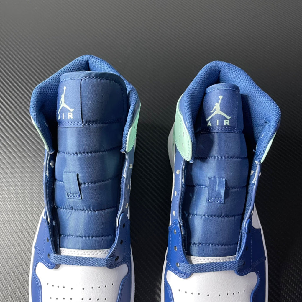 Back collar of blue mid-top sneakers with Air and Jumpman logos