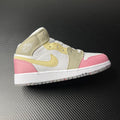 Air Jordan 1 Mid sneakers with white, pink, and gold color blocking and lace-up design