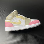 Air Jordan 1 Mid sneakers with white, pink, and gold color blocking and lace-up design