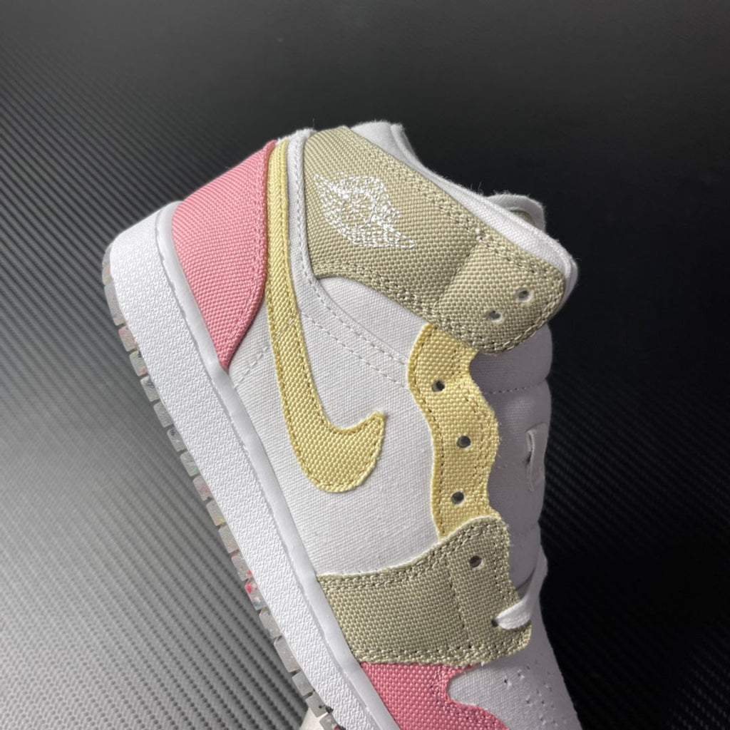 Air Jordan 1 Mid sneaker back quarter view with pink heel panel and gold accents