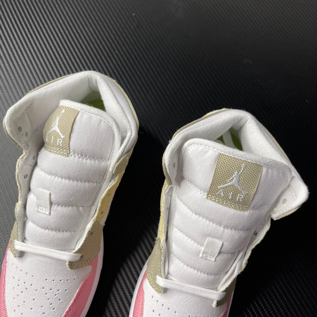 Air Jordan 1 Mid pair shown from upper angle with white padded tongue and gold heel tabs