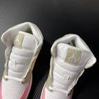 Air Jordan 1 Mid pair shown from upper angle with white padded tongue and gold heel tabs