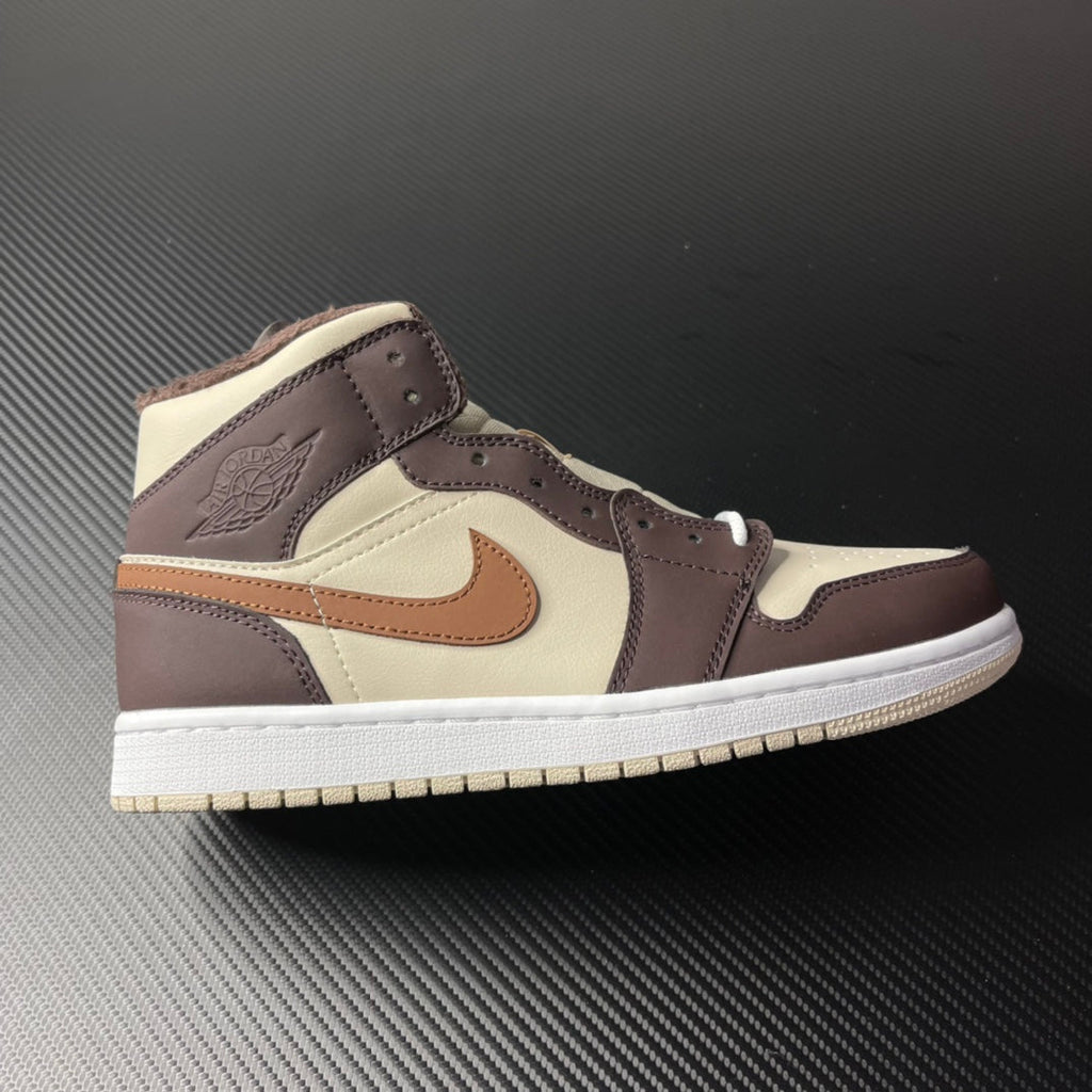 Mid-top Air Jordan 1 sneaker with cream, dark brown, tan swoosh and white sole