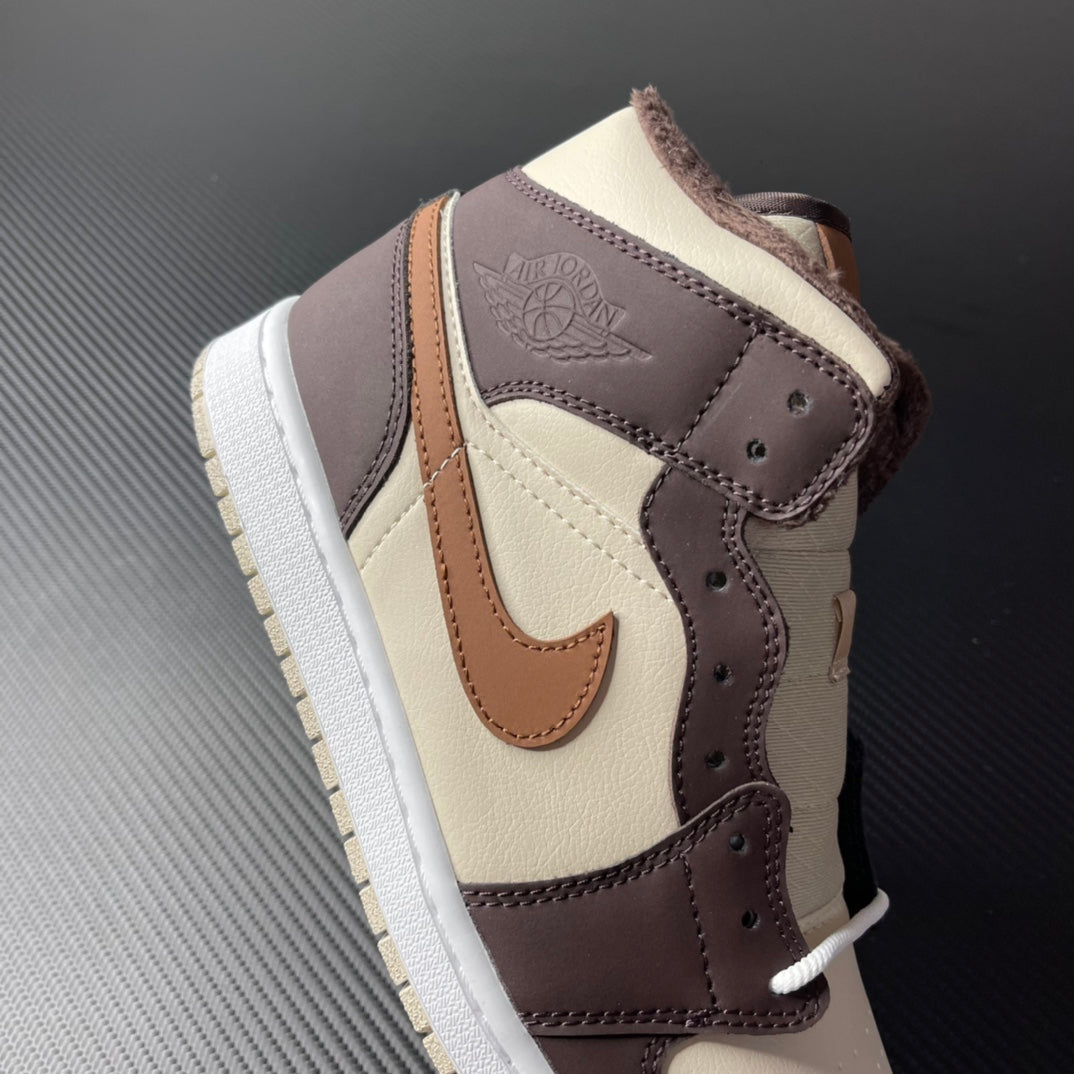 Mid-top Air Jordan 1 side view, cream toe with dark brown collar and tan strap detail