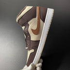 Mid-top Air Jordan 1 shoe with cream base, dark brown panels and tan swoosh on side