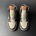 Air Jordan 1 mid-top pair, cream uppers with dark brown collars and tan laces