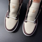Air Jordan 1 mid-top pair, cream toe boxes with white laces and dark brown heel panels