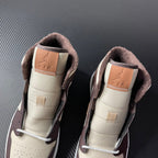 Air Jordan 1 mid-top pair back view, cream lining with dark brown suede collar and Air logo