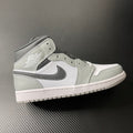 Light gray and white Air Jordan 1 Mid sneaker, black swoosh, mid-top