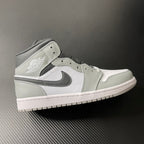 Light gray and white Air Jordan 1 Mid sneaker, black swoosh, mid-top