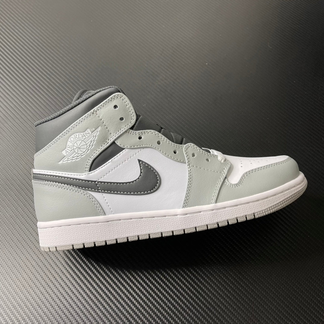 Light gray and white Air Jordan 1 Mid sneaker, black swoosh, mid-top
