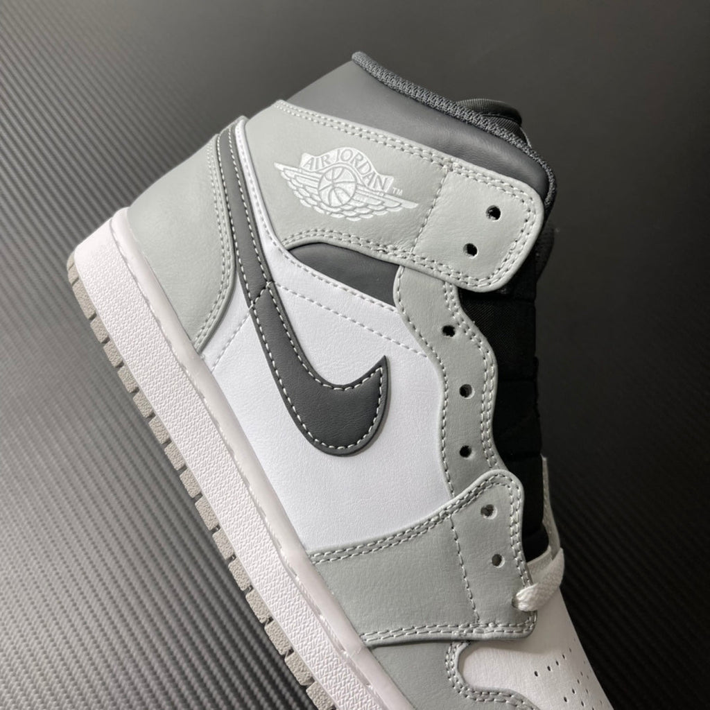 Light gray and white mid-top sneaker with Air Jordan wings heel logo patch