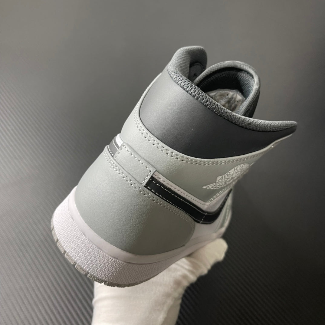 Light gray mid-top sneaker with black heel collar lining and back strap