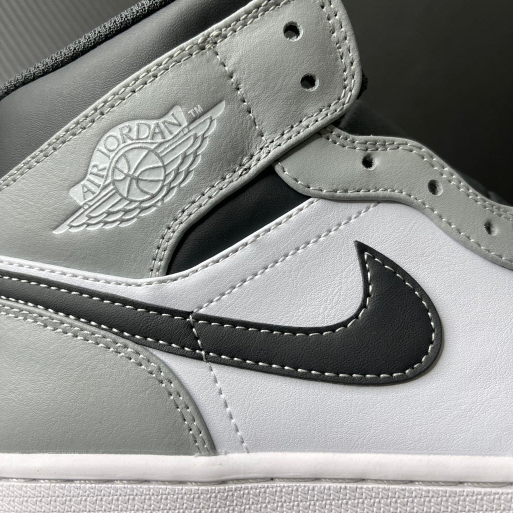 Light gray leather mid-top sneaker with embroidered Air Jordan wings logo