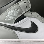 Light gray leather mid-top sneaker with embroidered Air Jordan wings logo