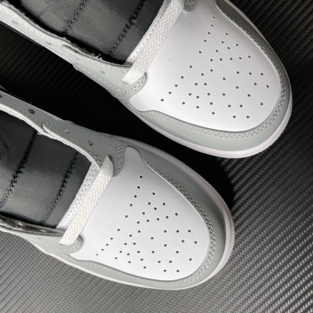 White and light gray mid-top sneakers with perforated toe box