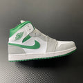 Mid-top sneakers with white leather, green accents, and gray panels