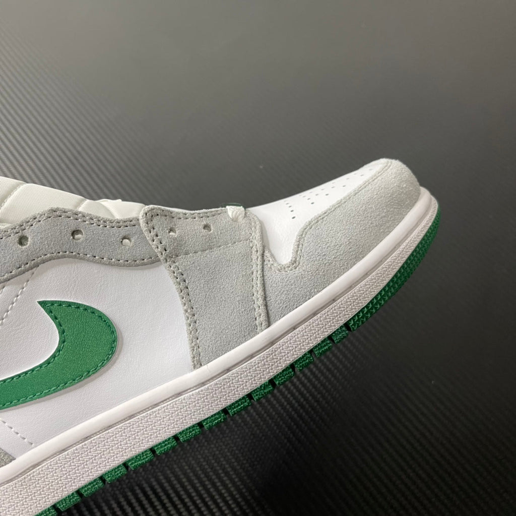 Mid-top sneaker close-up with white upper, green stripe trim, and gray collar