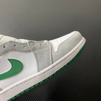 Mid-top sneaker close-up with white upper, green stripe trim, and gray collar