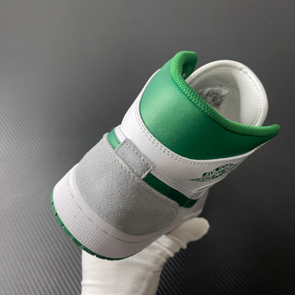 Mid-top sneaker heel view in white leather with green collar and gray panel