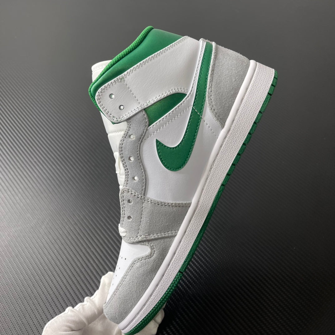 Mid-top sneaker side view with green Swoosh, white leather, and gray overlays