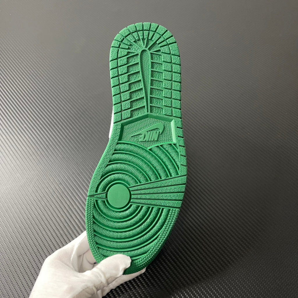 Green rubber outsole with textured tread pattern for mid-top sneakers