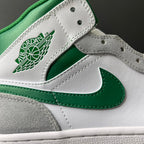 Air Jordan logo patch and green Swoosh on white leather mid-top sneaker