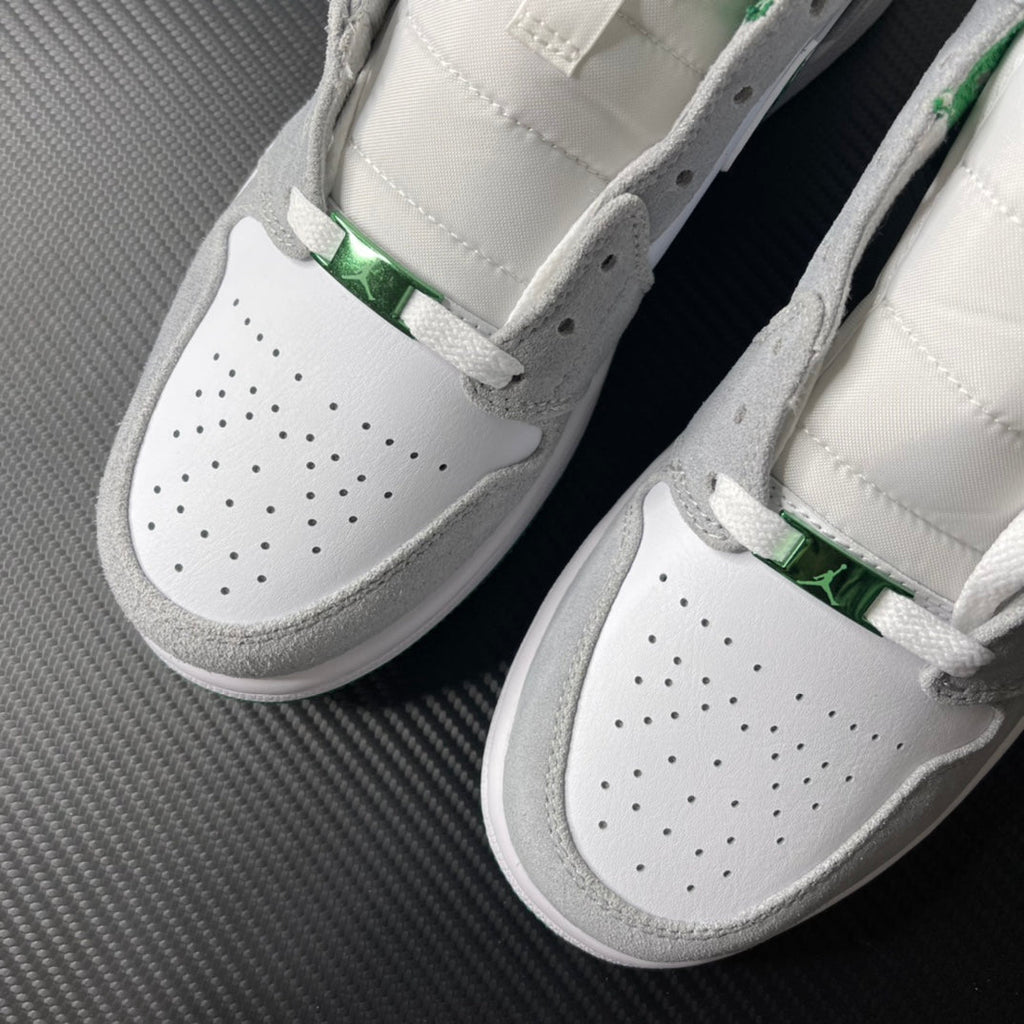Pair of sneakers with perforated white toe, green detail, and gray suede trim