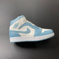 Jordan 1 Mid sneakers in white and light blue with blue swoosh and perforated toe