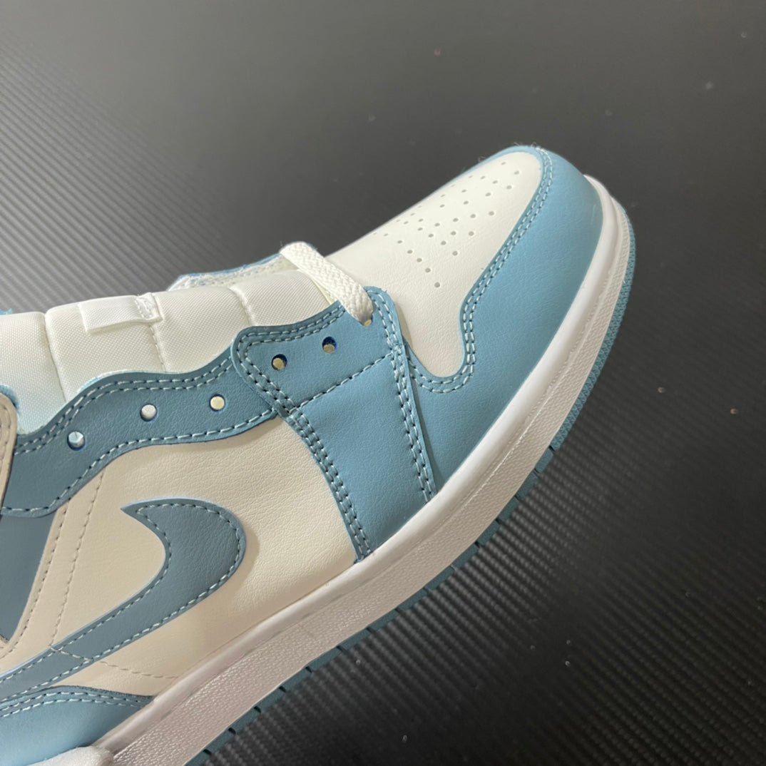 Jordan 1 Mid sneaker close-up: light blue overlays with stitching and swoosh on white leather