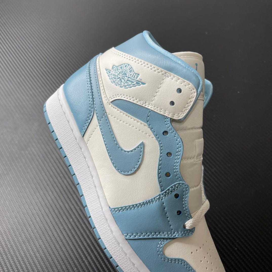 Jordan 1 Mid sneaker angled view with light blue collar and wing logo on white panel