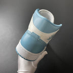 Jordan 1 Mid sneaker heel in light blue and white with stitched collar and ankle padding
