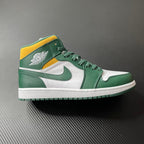 Mid-top sneakers with green leather, white panels, and yellow ankle collar.