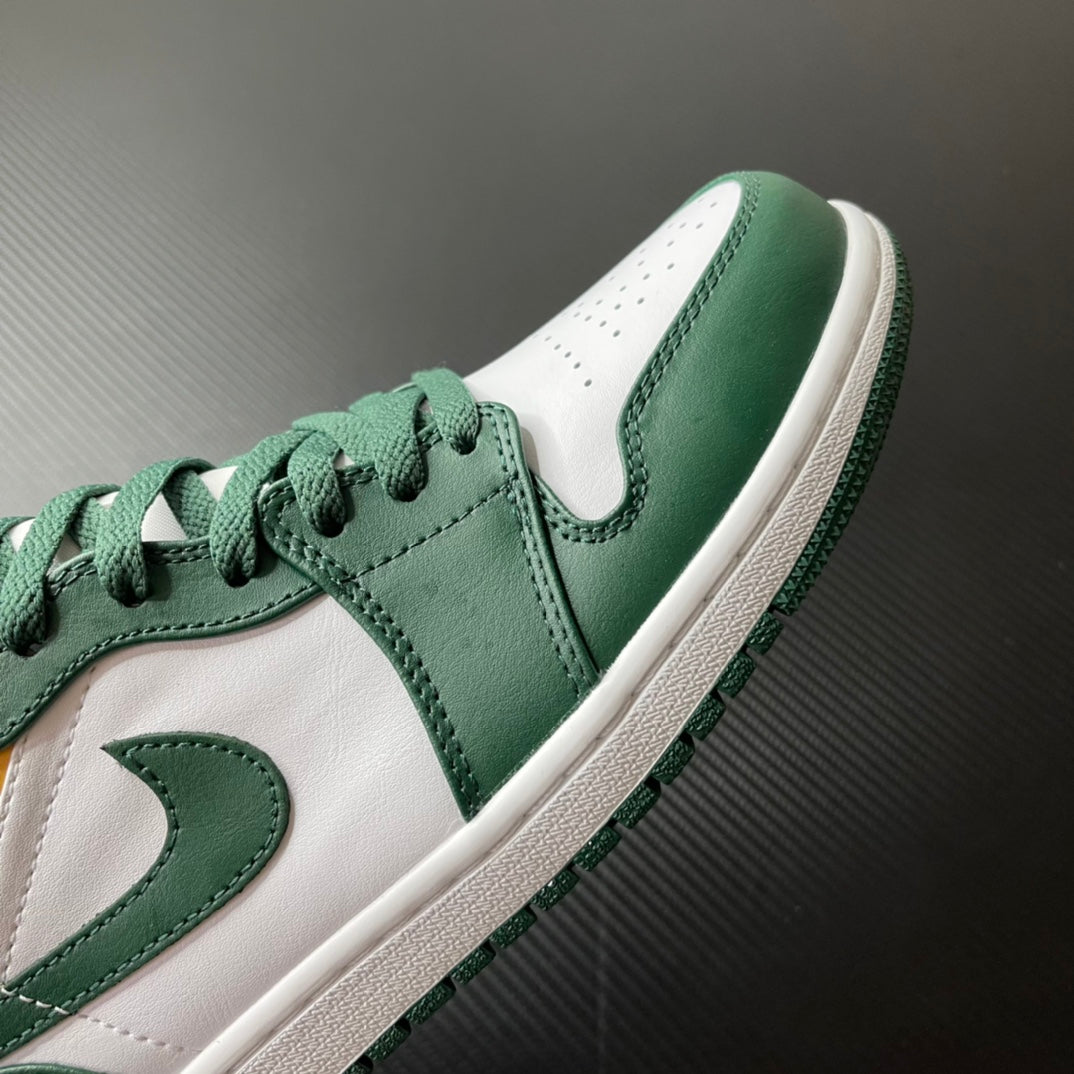 Mid-top sneakers toe and side view; green leather with white accents and lace-up.