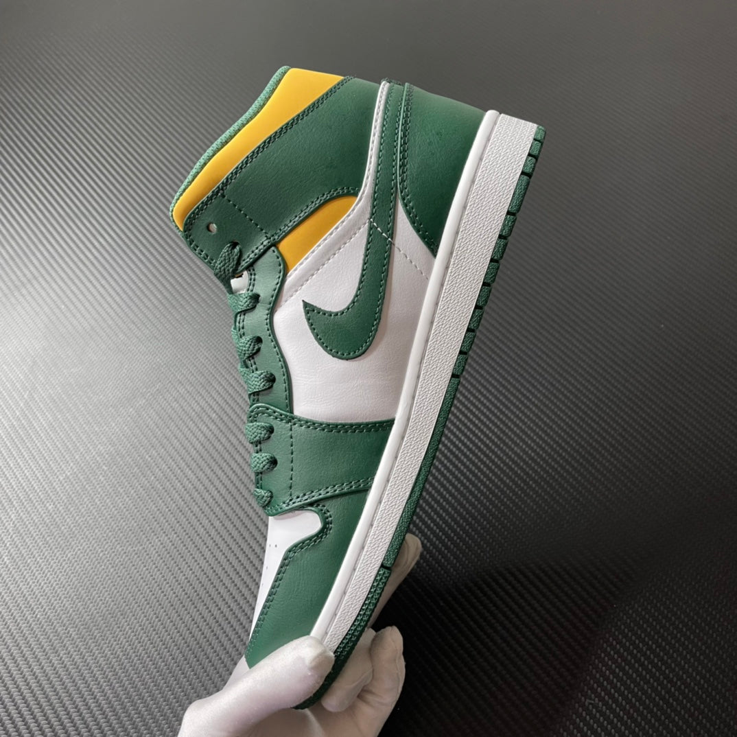 Mid-top sneakers side view; green overlays, white panels, yellow collar, lace-up.