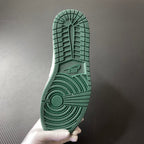Shoe outsole in green with grippy tread pattern and circular heel traction.