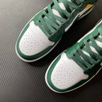 Pair of mid-top sneakers with green uppers and white perforated toe boxes.