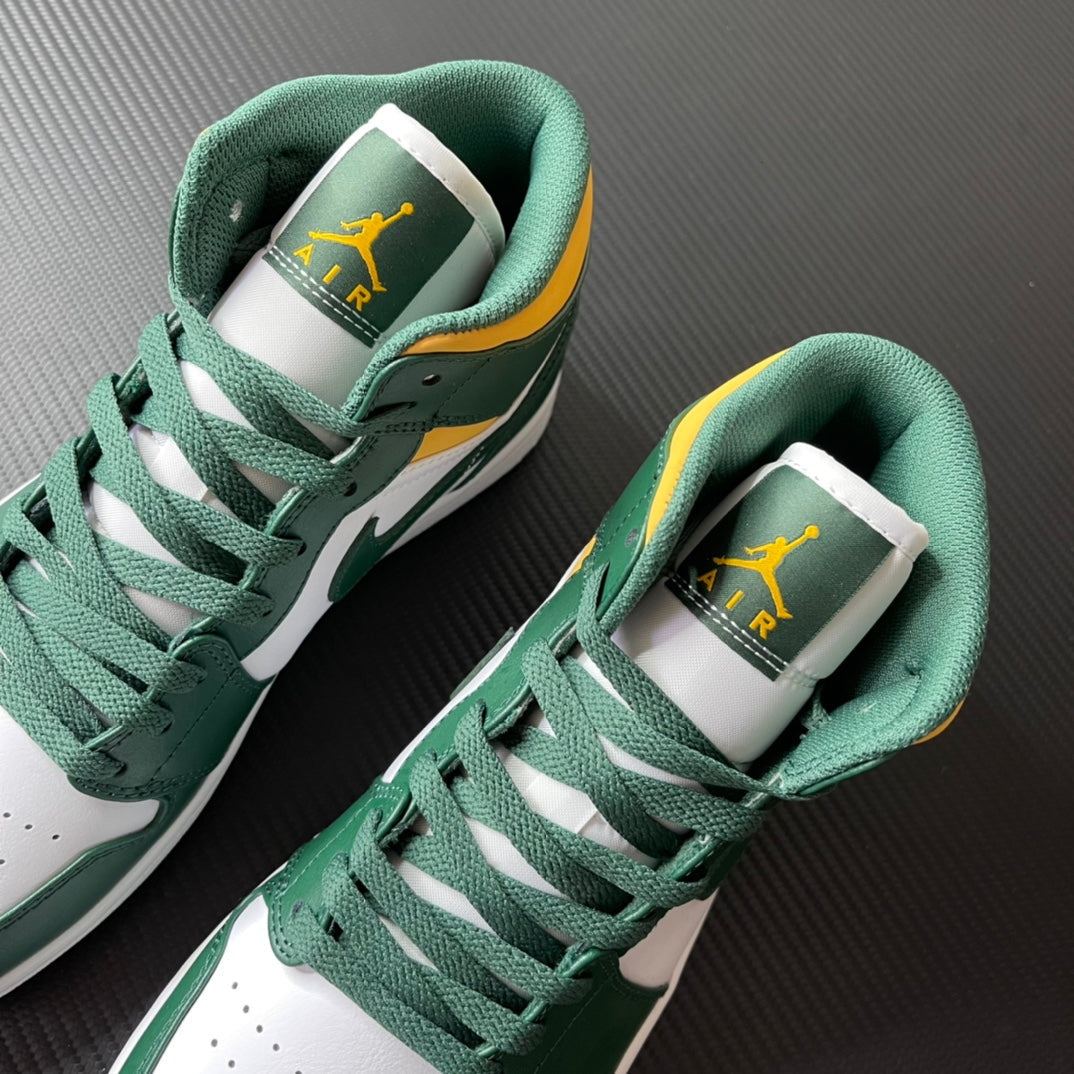 Pair of mid-top sneakers showing green laces and insoles with Air Jordan branding.