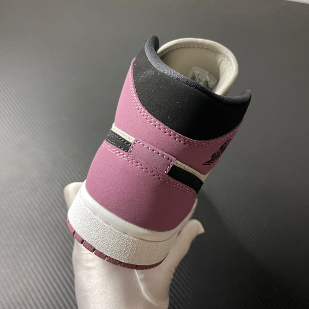 Mid-top sneakers heel view with black collar lining and berry pink upper