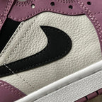 Mid-top sneakers close-up of black swoosh on white and berry pink panels