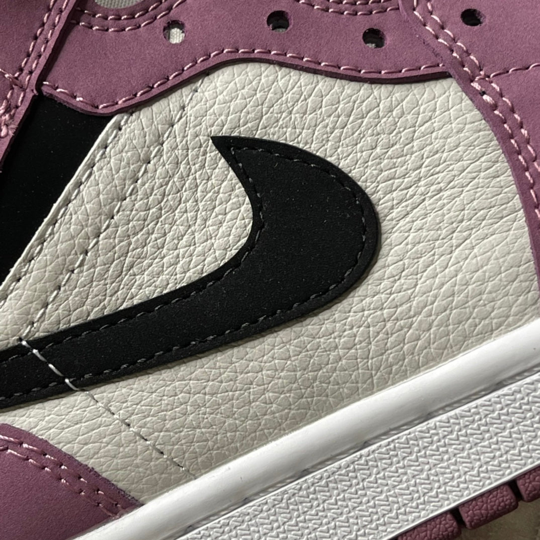 Mid-top sneakers close-up of black swoosh on white and berry pink panels