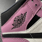 Mid-top sneakers side close-up with Air Jordan Wings logo on berry pink patch