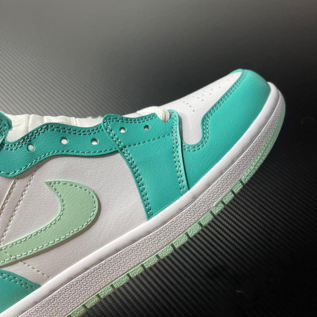 Low-angle view of a white and teal mid-top sneaker with stitched Swoosh panel