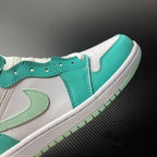 Low-angle view of a white and teal mid-top sneaker with stitched Swoosh panel