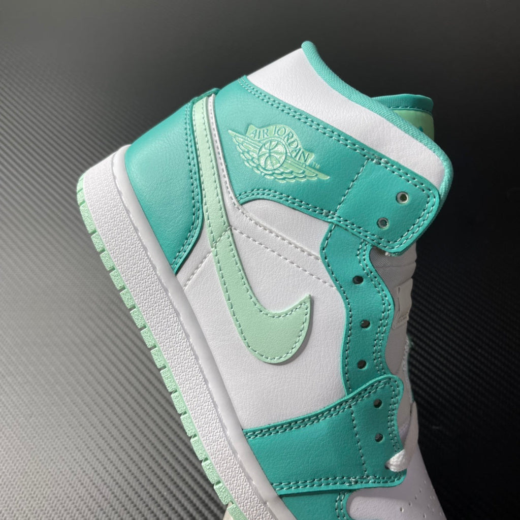 Mid-top sneaker in white and teal with lace eyelets and embossed wing logo