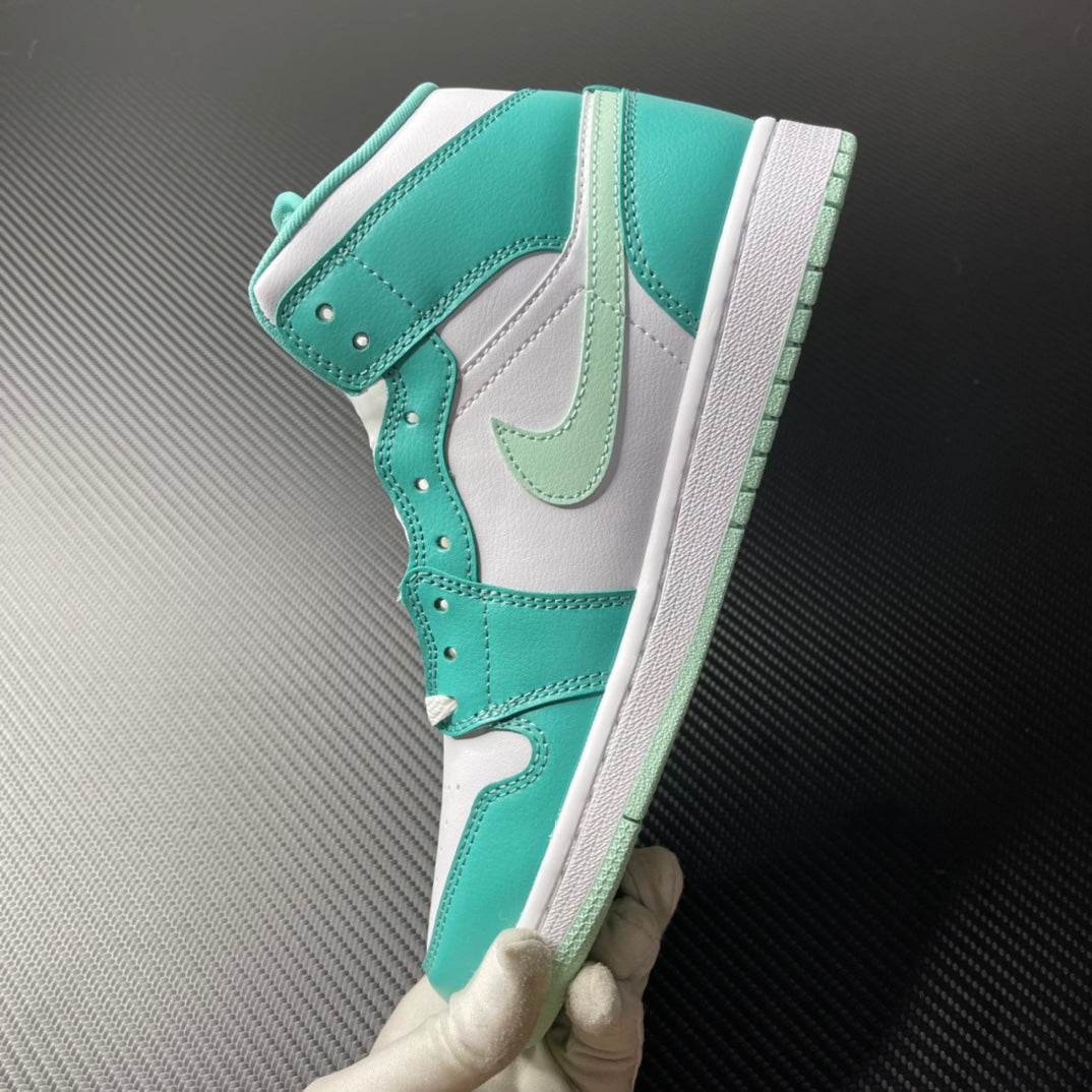 Side profile of a white and teal mid-top sneaker with Swoosh and perforated details