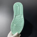 Teal rubber outsole with textured traction pattern and circular logo