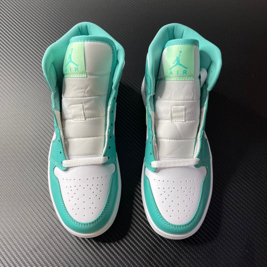 Pair of white and teal mid-top sneakers shown from the heel with air logo