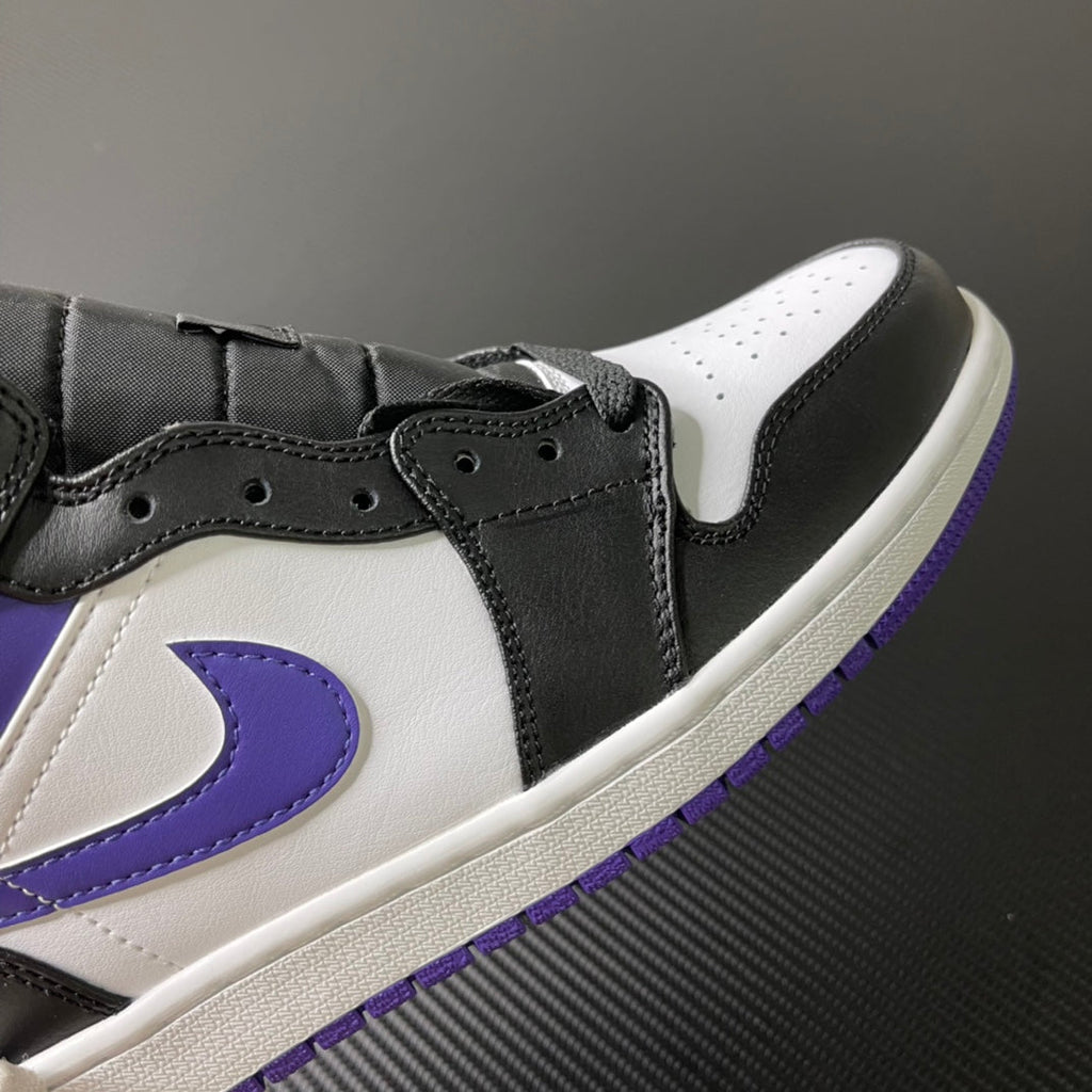 Black and white Air Jordan 1 Mid with purple swoosh, lace eyelets, and perforations